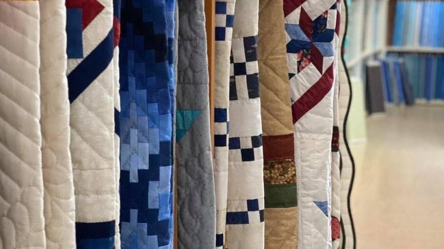 Rack of quilts at Lone Star Quilt Shop